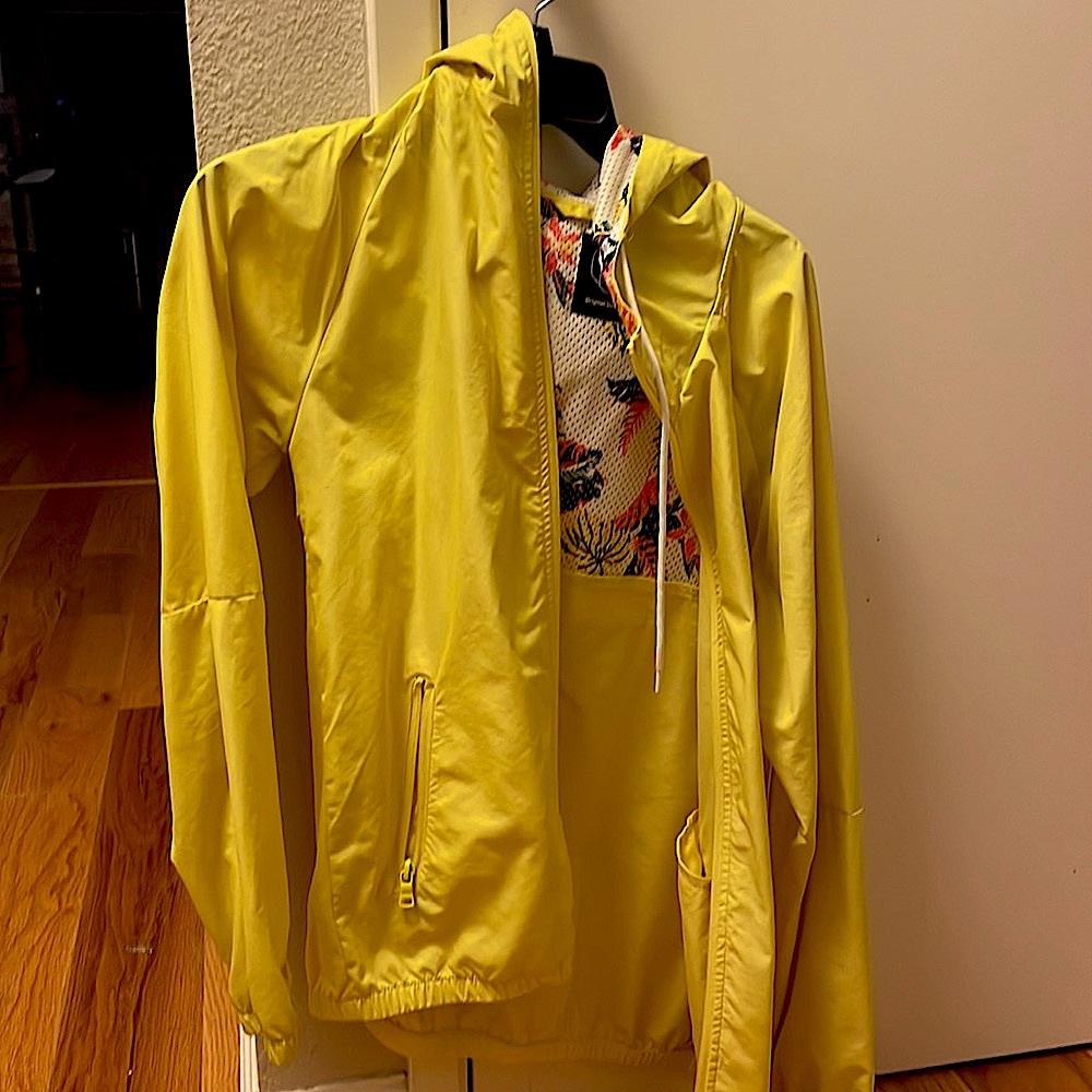 Yellow hooded zip windbreaker with floral hood interior